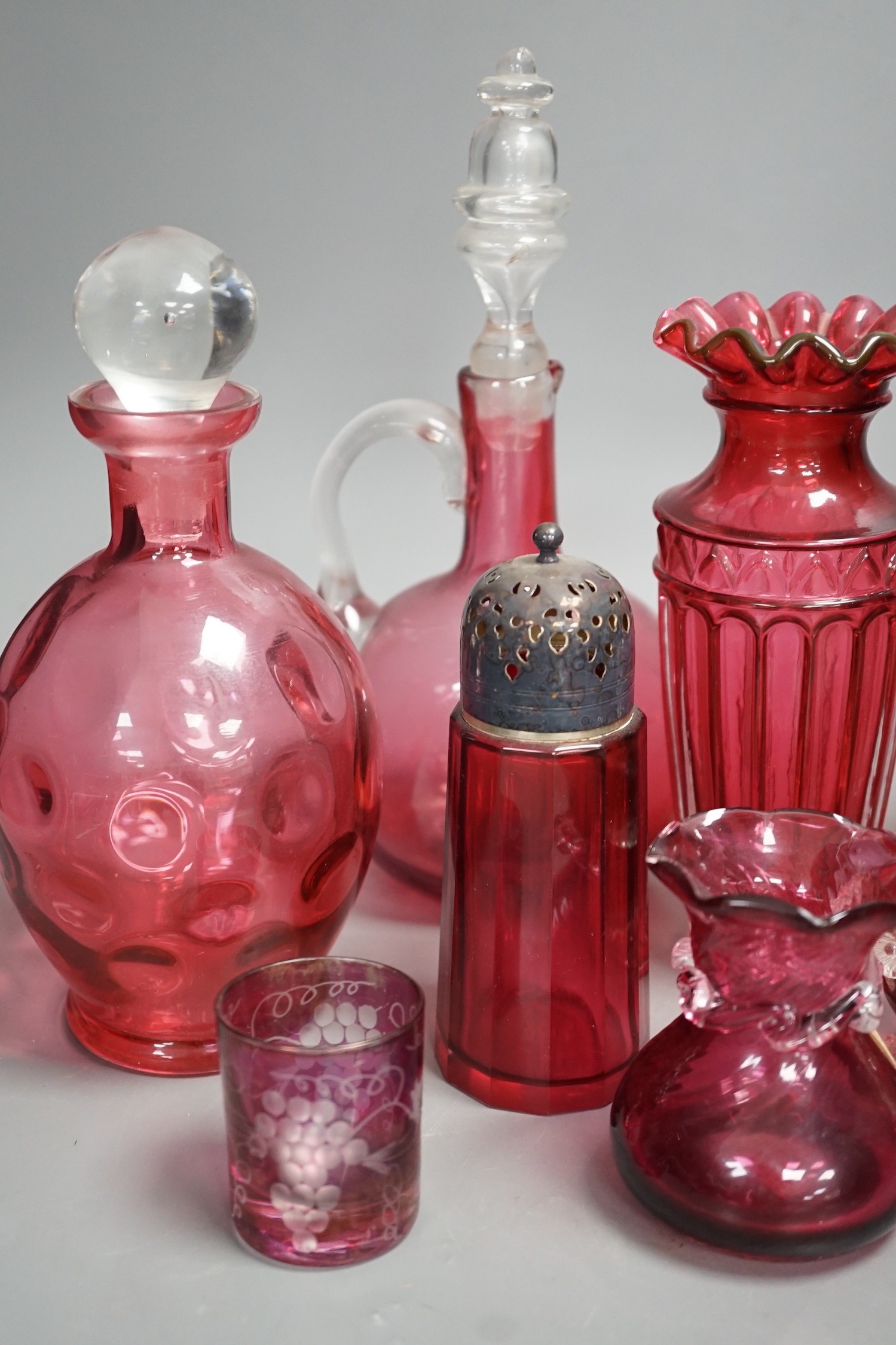 A Mary Gregory style cranberry decanter together with mixed cranberry glass (10), Mary Gregory decanter 25cms high including stopper